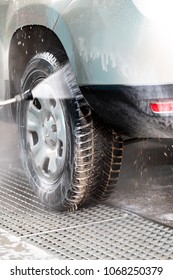 High Pressure Water Stream Washing A Car At Handwash Car Station. Vertical Close Up Crop