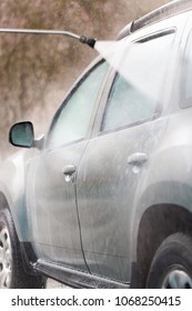 High Pressure Water Stream Washing A Car At Handwash Car Station. Vertical Close Up Crop