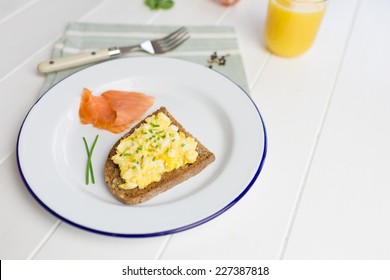 High Protein Breakfast With Scrambled Eggs On Toast, Smoked Salmon, Fresh Orange Juice And Green Salad