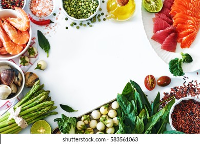 High Protein Dinner Ingredients Food Frame. Salmon And Tuna Sashimi, Cooked Shrimps, Clamps, Brown Rice, Asparagus, Spinach, Olive Oil, Salt And Pepper. White Background, Copy Space.