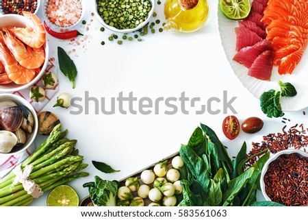 High protein dinner ingredients food frame. Salmon and tuna sashimi, cooked shrimps, clamps, brown rice, asparagus, spinach, olive oil, salt and pepper. White background, copy space.