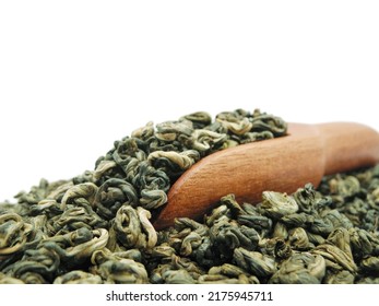 High quality green tea with wooden scoop close up on white background with copy space