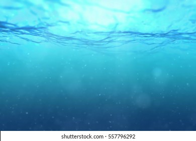 High Quality Perfectly Seamless Loop Of Deep Blue Ocean Waves From Underwater Background With Micro Particles Flowing, Light Rays Shining Through