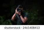 High quality photo of photographer taking picture of nature, Wildlife photography concept image, photography advertising banner type photo