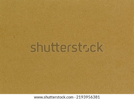 High quality scan large image of an recycled brown cardboard paper texture background with colorful particles and fine, smooth fiber grain with copyspace for text for mockups or wallpapers