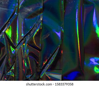 High Res Full Frame Macro Photo Of Abstract Pastel Iridescent Holographic Foil Background With Light Leaks. Holo Color Wrinkled Material. Backside Of Sticker. Glitter Surface With Shiny Rainbow Feel.