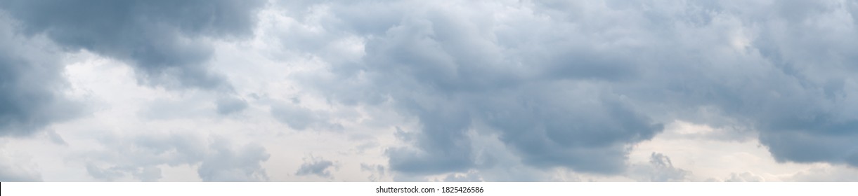 High resolution (54 megapixels) wide format photo of a dramatic overcast sky, with grey clouds. Taken in the afternoon. Freedom, storm, beauty of nature.