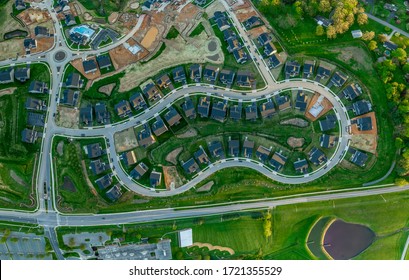 High Resolution Aerial View Of A New Residential Real Estate Development With Single Family Houses, Home Sites, Community Pool, Curving Streets In The East Coast USA