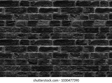 High resolution black seamless brick wall texture pattern background. Seamless worn style burned style brick wall background. Black grey brick wall pattern worn texture. Worn style seamless brick wall