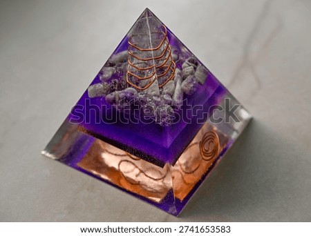 High resolution color image of a Large Handmade Orgonite Pyramid with Amethyst Crystals – Symmetrical Copper Design on White Marble Background