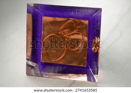 High resolution color image of a Large Handmade Orgonite Pyramid with Amethyst Crystals – Symmetrical Copper Design on White Marble Background