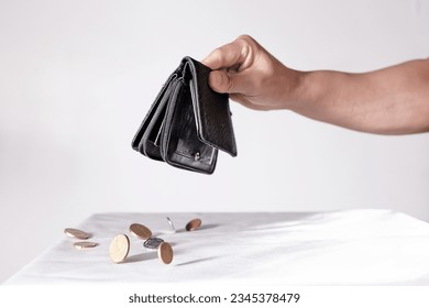 A high resolution image of a hand throwing cash, euro coins out of a wallet. Representing the upcoming digital coin and digital euro. Also representing financial problems like bankruptcy. One person.
