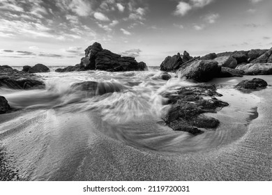 High Resolution Ocean Landscape With A Detailed Sand And Rock Foreground In Black And White Image Format
