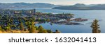 A high resolution panorama of the Kelowna British Columbia skyline and Okanagan Lake with the R W Bennett Bridge in the background, from Knox Mountain at sunset