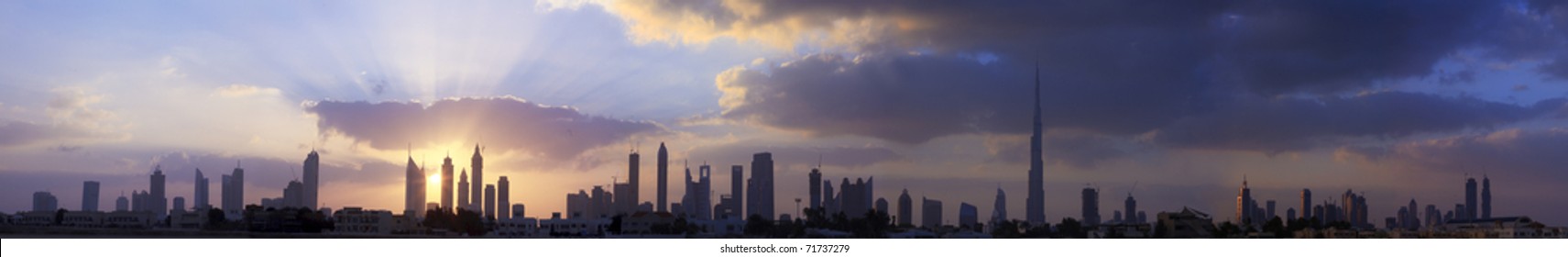 High Resolution Panoramic View Of Dubai Buildings Including Burj Khalifa With Beautiful Clouds And Sunrise Background.