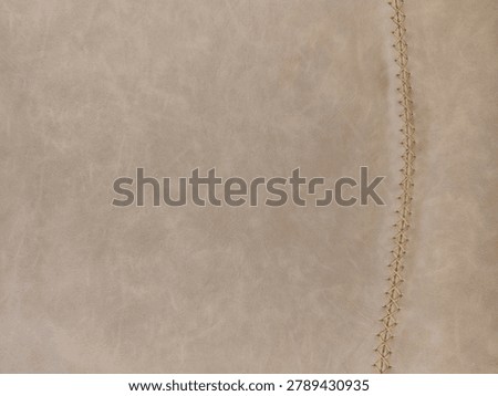 High Resolution PBR Texture of Greige Distressed Leather, Vintage Taupe Faux Hide Surface with Decorative Cross Stitch Seam, Albedo Map for Interior Archviz and Apparel 3D Asset Design
