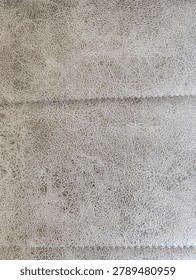 High Resolution Seamless PBR Texture of Crackled Greige Leather, Distressed Vintage Taupe Hide Surface with Horizontal Stitched Seam, Albedo Map for Interior Archviz and Premium Furniture 3D Asset Design
