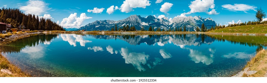 High resolution stitched panorama of a beautiful alpine summer view with reflections in a lake at the famous Astberg summit, Going, Wilder Kaiser, Tyrol, Austria - Powered by Shutterstock