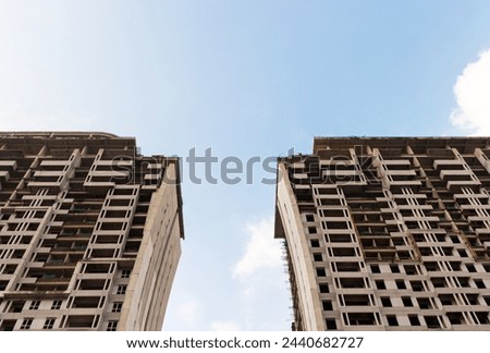 High rise apartment building under construction with blue sky background in the afternoon. After some edits.