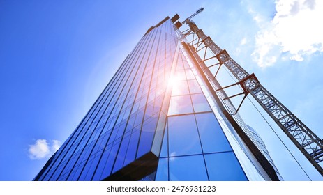 High rise building under construction. Installation of glass facade panels on a reinforced concrete structure. - Powered by Shutterstock