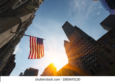 High Rise Buildings And US Flag, Business District, New York City. Focus On Flag