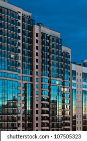 High Rise Modern Building Reflect Light At Dusk And Night