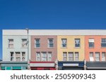 High Road Leyton, featuring pastel colourful terraced houses, in East London