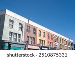 High Road Leyton, featuring pastel colourful terraced houses, in East London