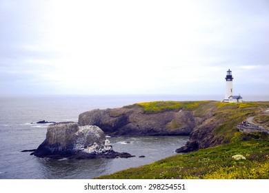 High round Lighthouse illuminates correct way for ships sailing in ocean prevent shipwreck as symbol of right direction in life goals, located on high cliff on Pacific coast. Place of tourists local 