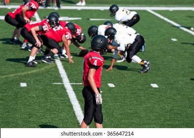 High School American Football Receiver Waiting For Play To Start During The Game.