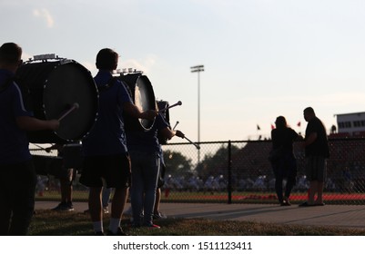 High School Band Members Play During A High School Football Game.