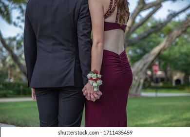 A High School Couple Dressed For Prom From Behind