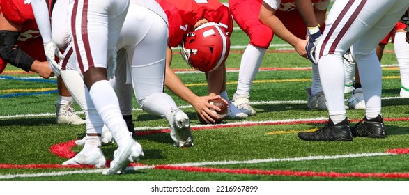 A High School Football Long Snapper Is Ready To Snap The Ball To The Punter During A Game.