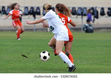 High School Girl Athletes Playing A Varsity High School Soccer Game.