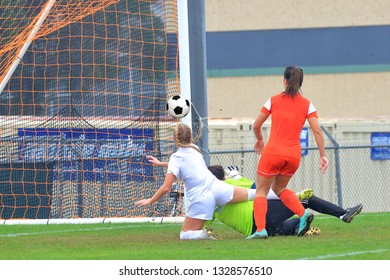 High School Girl Athletes Playing A Varsity High School Soccer Game.