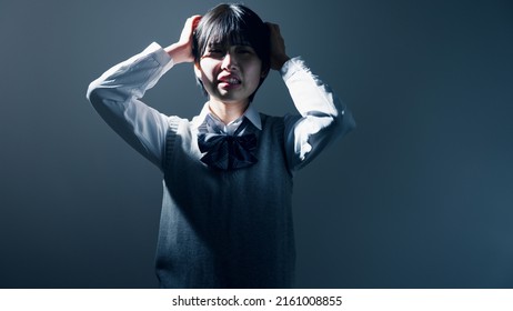 High School Girl With Her Head In Her Hands