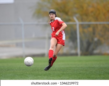 High School Girl Playing Soccer, Kicking The Ball.