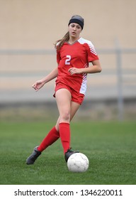 High School Girl Playing Soccer, Kicking The Ball.