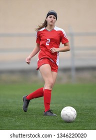 High School Girl Playing Soccer, Kicking The Ball.