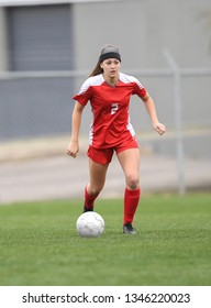 High School Girl Playing Soccer, Kicking The Ball.