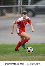 High School Girl Playing Soccer, Kicking The Ball.