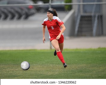 High School Girl Playing Soccer, Kicking The Ball.