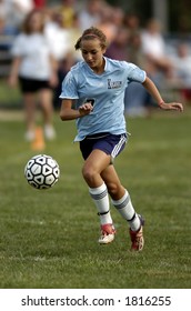 High School Girl Soccer Player Runs With Eye On The Soccer Ball