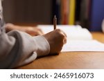 A high school girl studying for an exam in her room