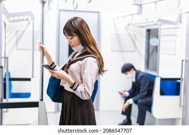 A High School Girl Wearing A Mask On The Train