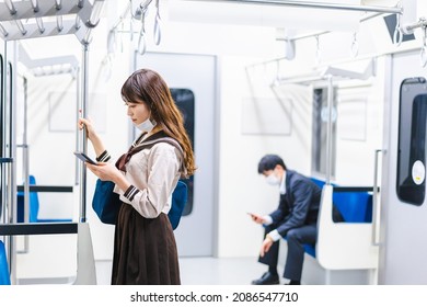 A High School Girl Wearing A Mask On The Train