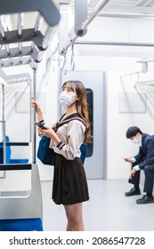 A High School Girl Wearing A Mask On The Train