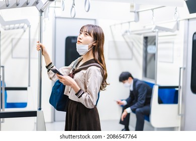 A High School Girl Wearing A Mask On The Train