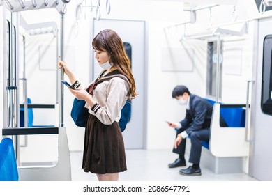 A High School Girl Wearing A Mask On The Train