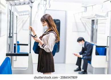 A High School Girl Wearing A Mask On The Train